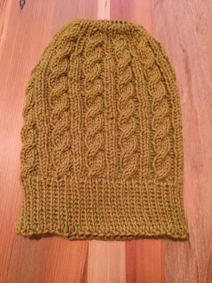 Cabled Messy Bun Hat  free knitting pattern | The Knit Guru